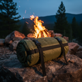 Tactical olive green survival sleeping bag rolled up on rocky outdoor surface