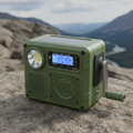 Emergency hand crank weather radio in olive green with solar panel and LED flashlight